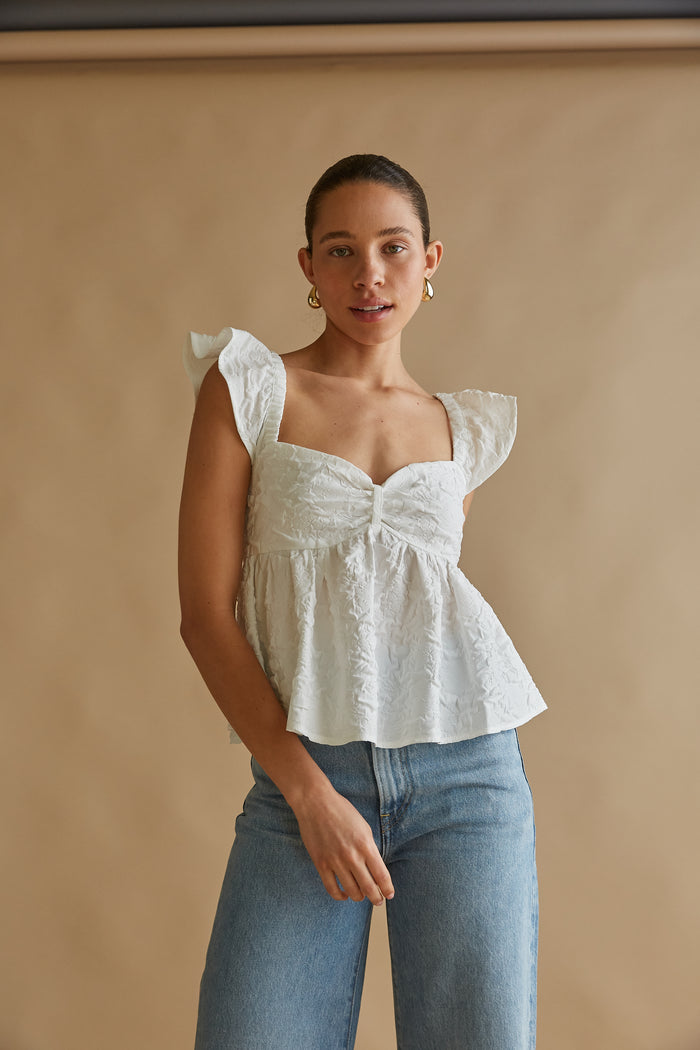 white flutter sleeve sweetheart neck peplum top with floral applique | white summer blouses 2024 