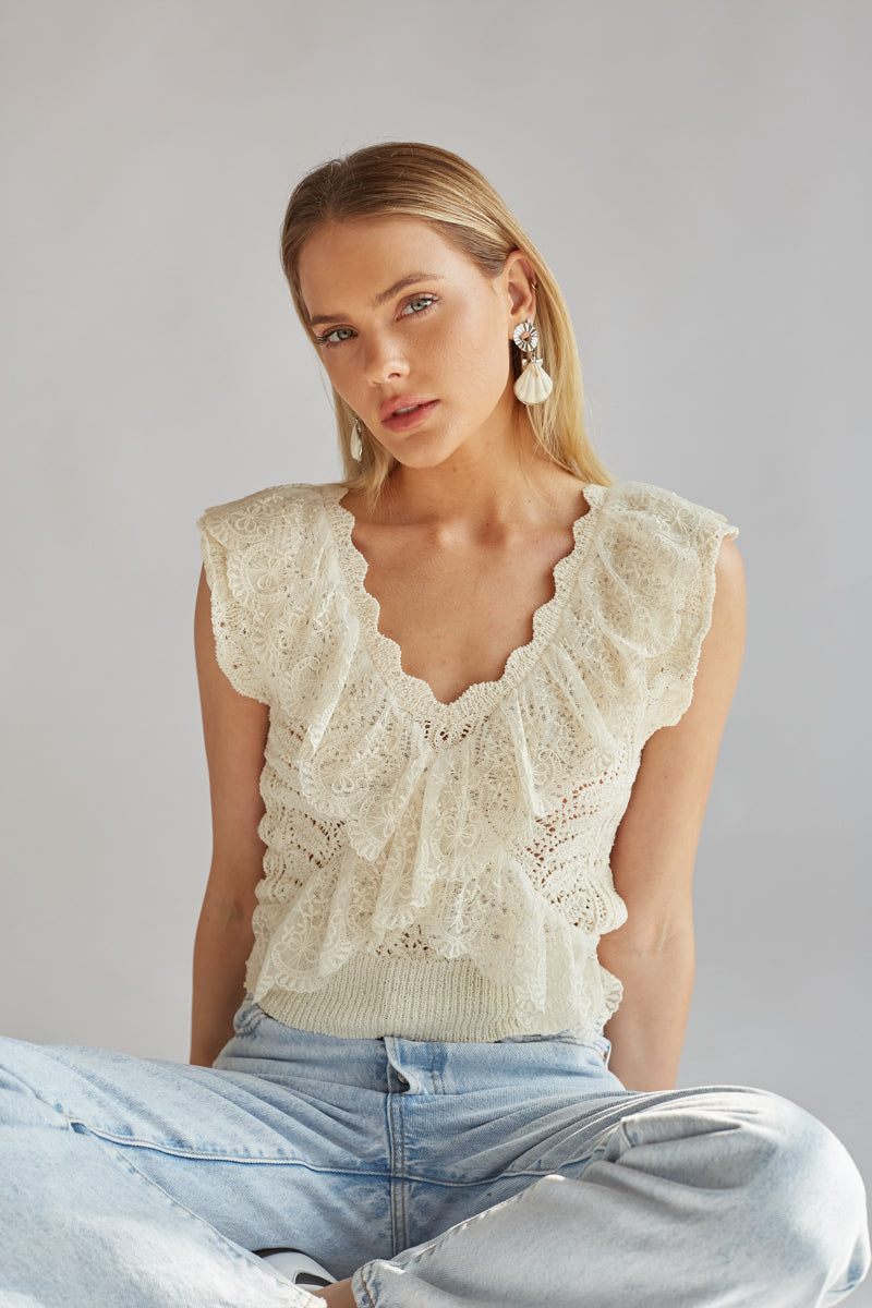 cream sleeveless v neck lace trim crochet top with criss cross ruffle detailing