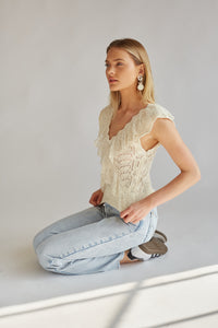 cream crochet lace detailing v neck sleeveless top with ruffles