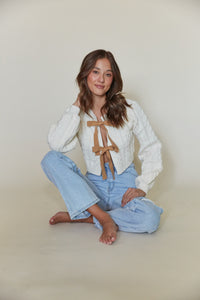 front view cream cable knit cardigan with tan bow closure - crew neck cropped cardigan