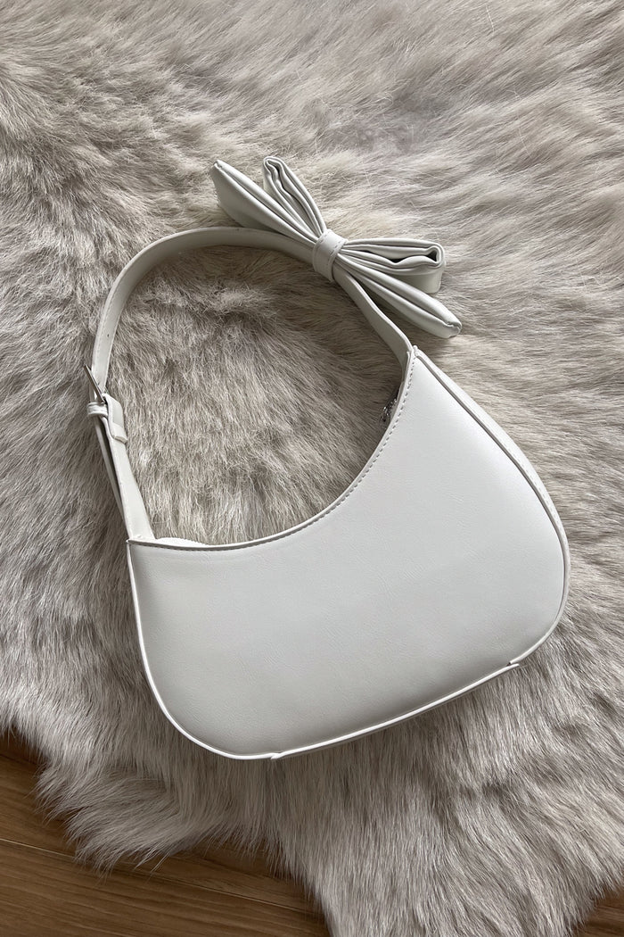 white asymmetrical hobo bag with bow strap detail | coquette purses for spring 2024