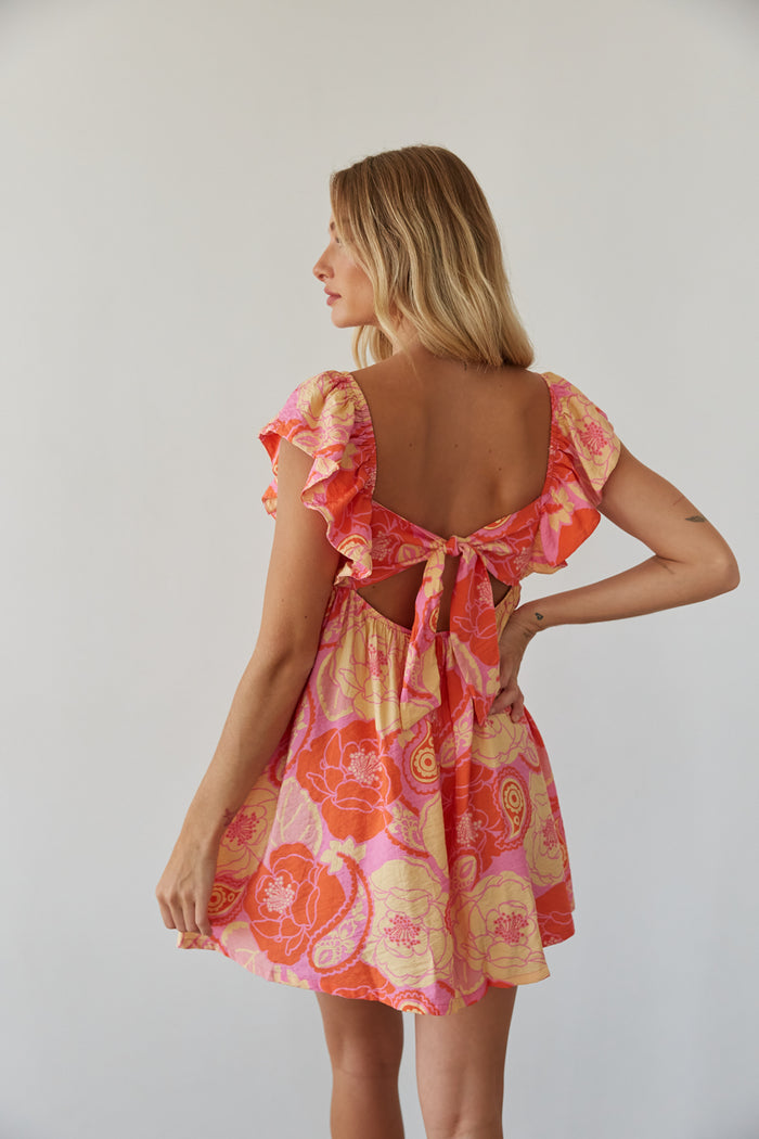 back view | orange floral flutter sleeve babydoll mini dress | open back mini dress