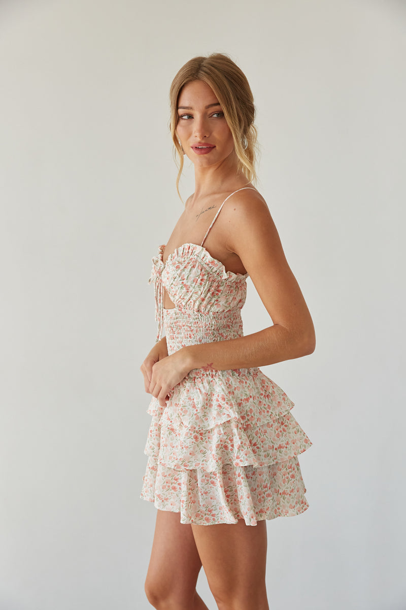 side view | pink floral romper with keyhole cutout, smocked waist, and tiered ruffle skirt 