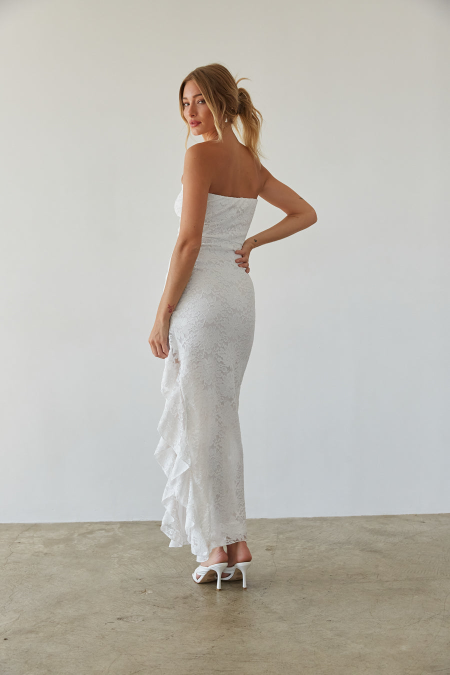 white sparkly strapless bodycon midi dress with ruffle hem | asymmetrical white dress
