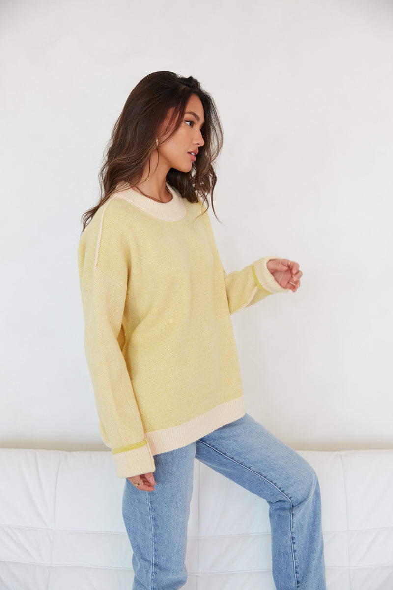 peach and yellow reversible sweater - pastel crew neck color block sweater - trendy winter outfit inspo - how to style colorful sweaters