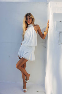white-image | Woman in a white dress standing against a white wall