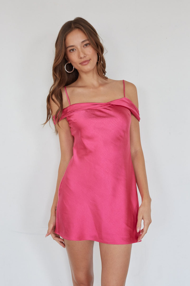 pink-image | Woman wearing a pink satin dress against a white background