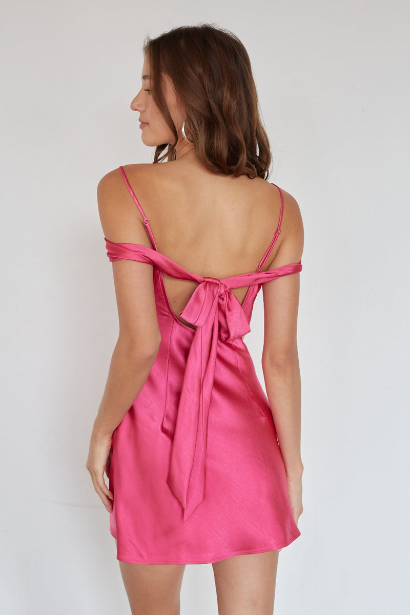 Pink dress with thin straps and open back on a white background