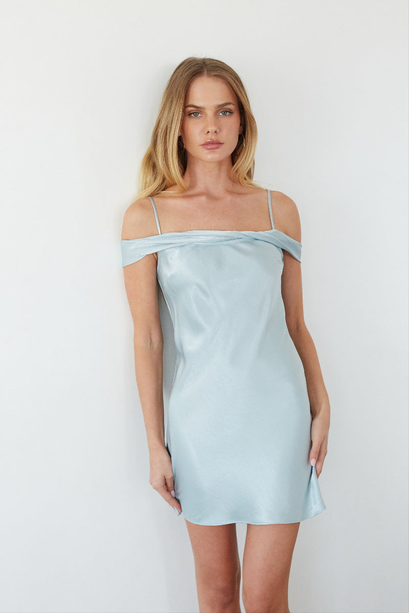 blue-image | Woman wearing a light blue satin dress against a white background