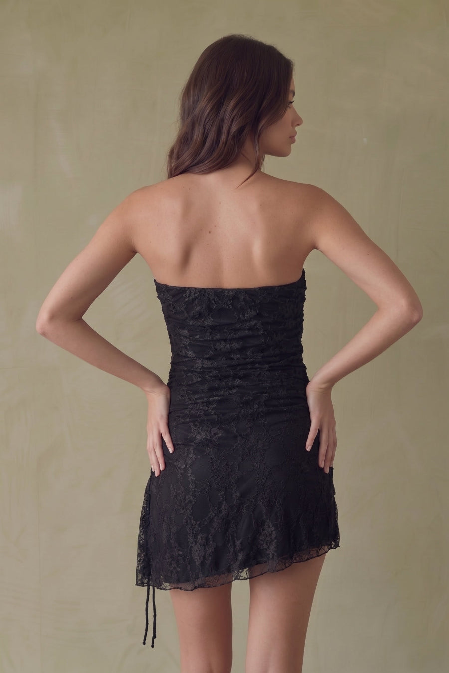 Back of a strapless black lace dress