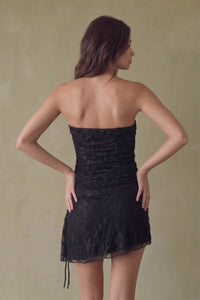 Back of a strapless black lace dress