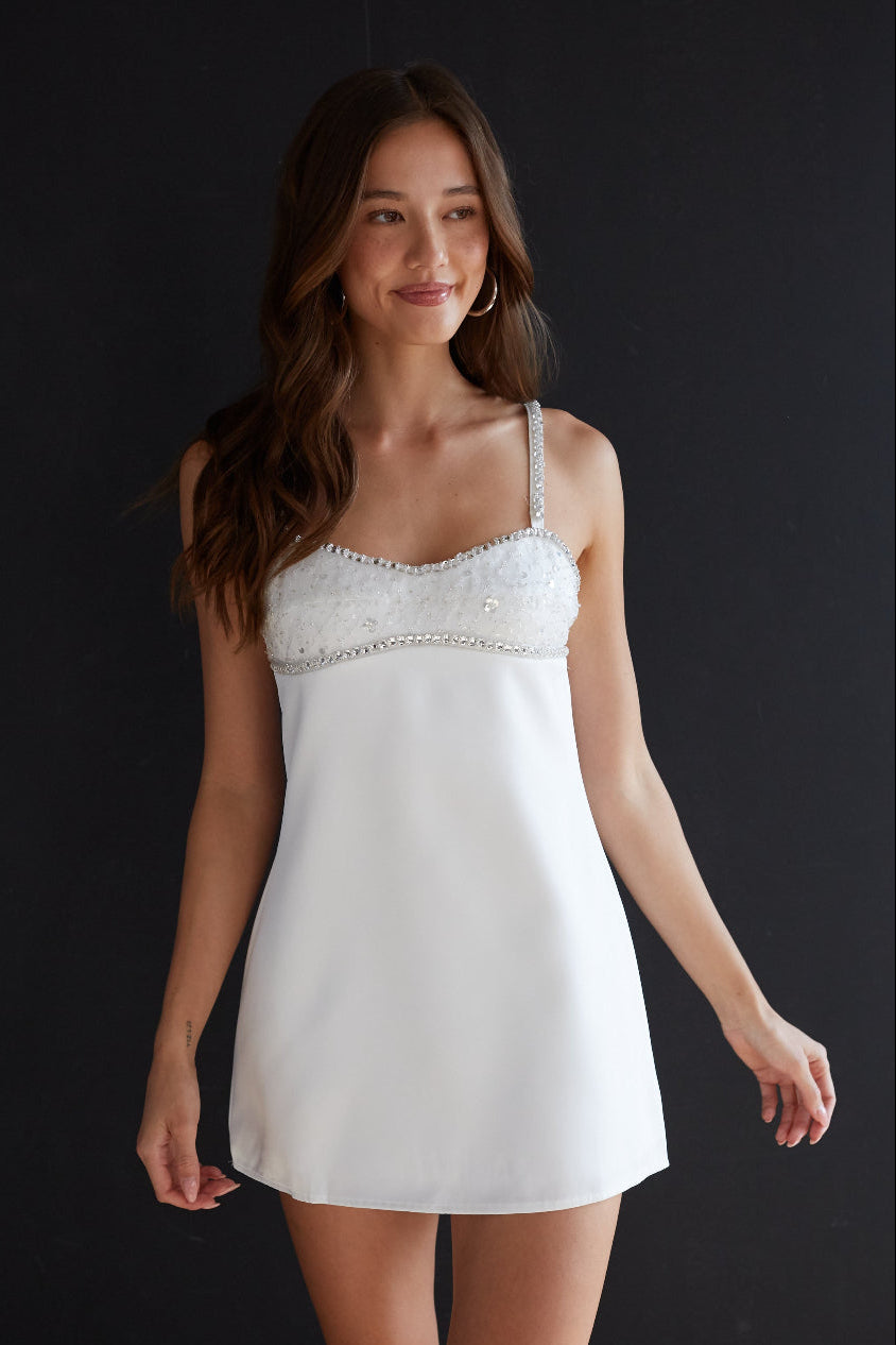 white-image | Woman wearing a white lace nightgown against a black background