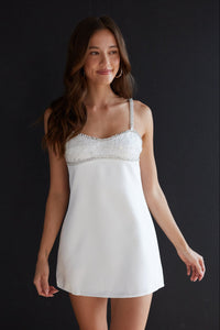 white-image | Woman wearing a white lace nightgown against a black background