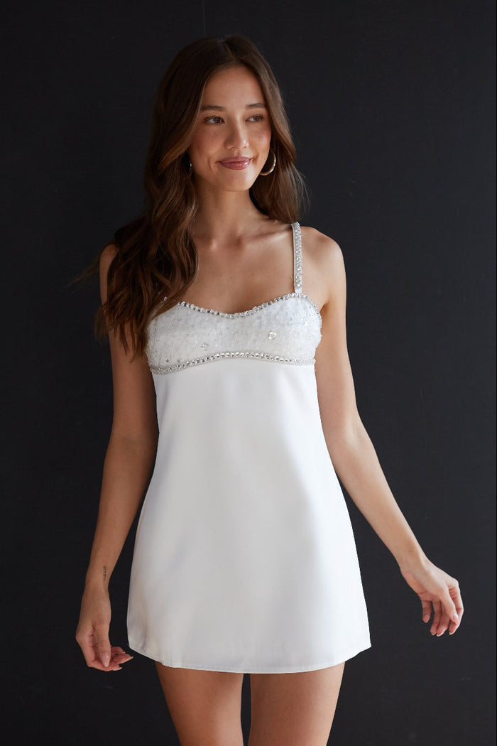 white-image | Woman wearing a white lace nightgown against a black background