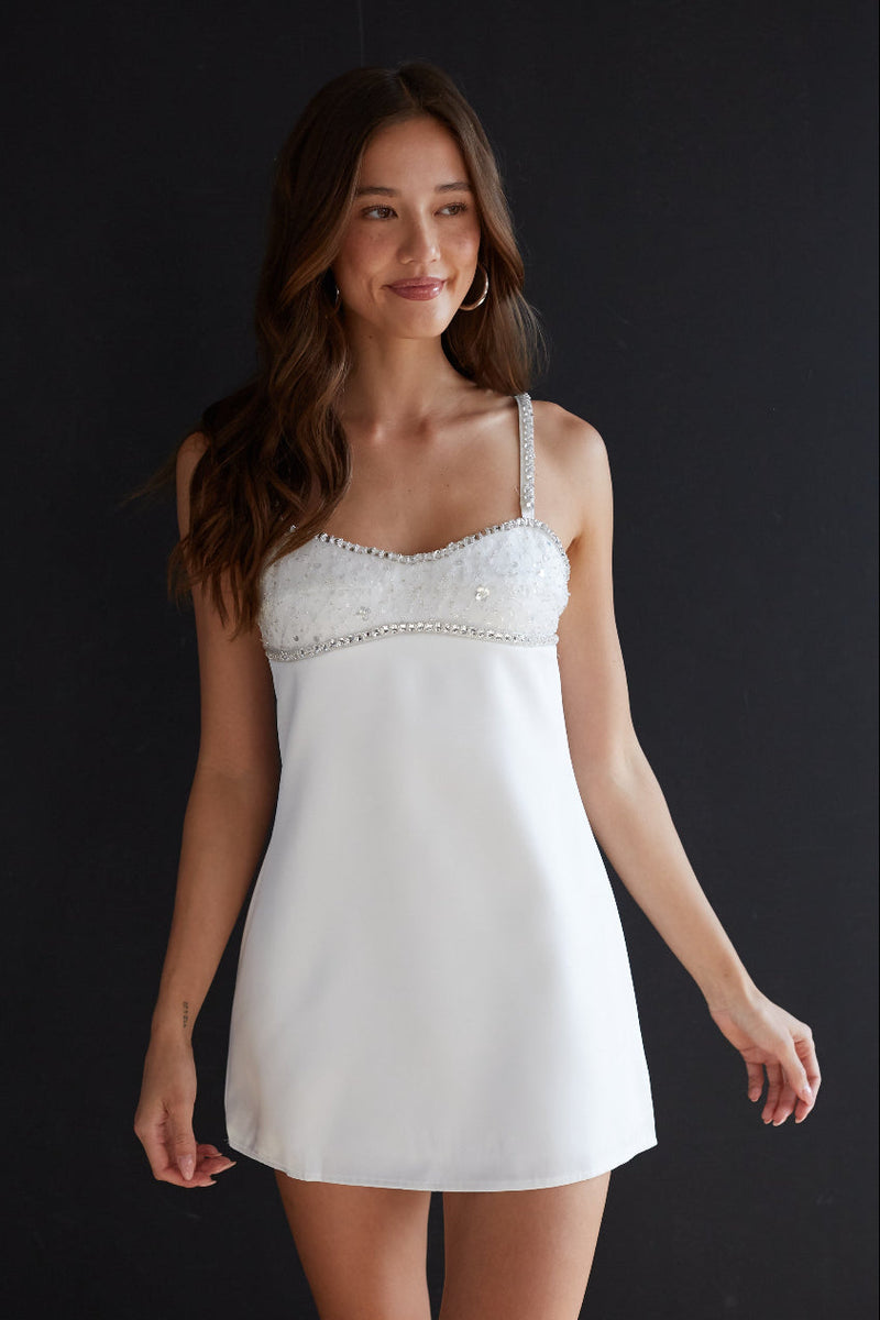 white-image | Woman wearing a white lace nightgown against a black background