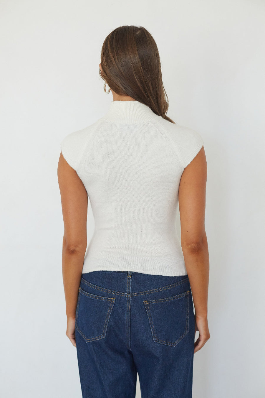 White turtleneck knit crop top, back view on model