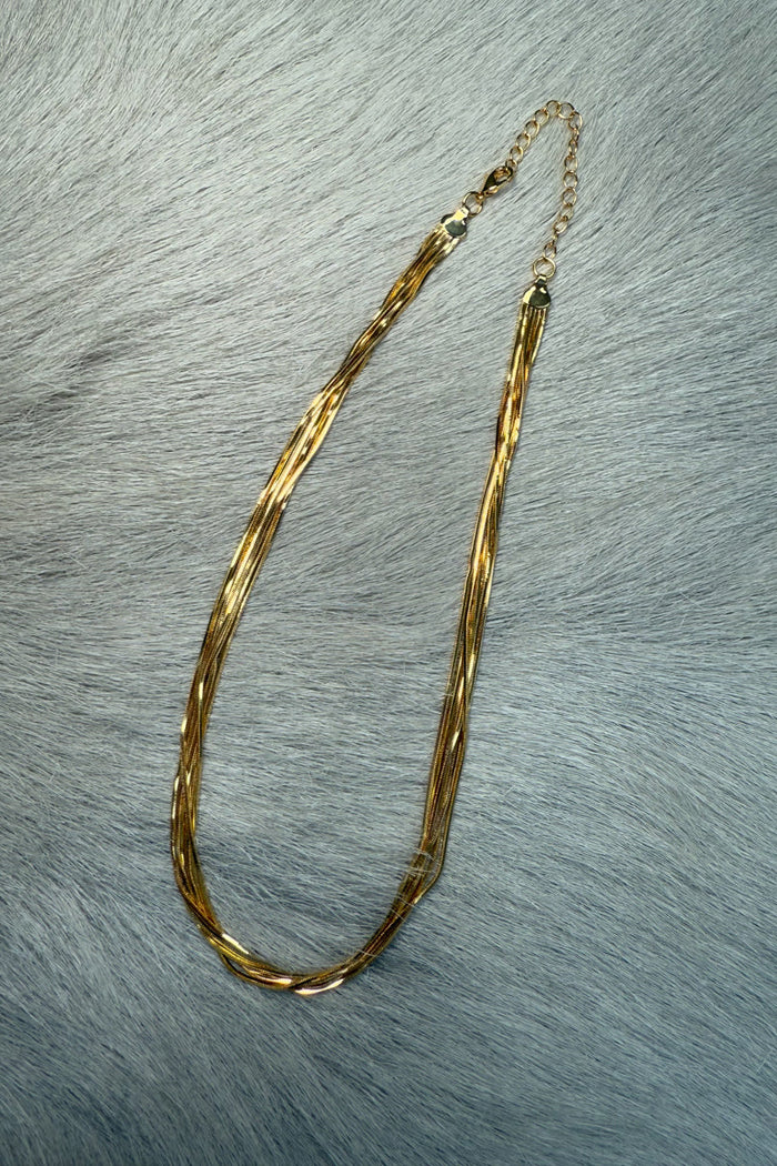 gold-image | overhead-image | multi-layer gold necklace | layered design | top-down view of a multi-layered gold necklace with smooth, twisted chains