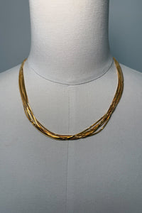 front-image | layered gold necklace | trendy jewelry | front view of a chic multi-layer gold necklace with intertwining chains