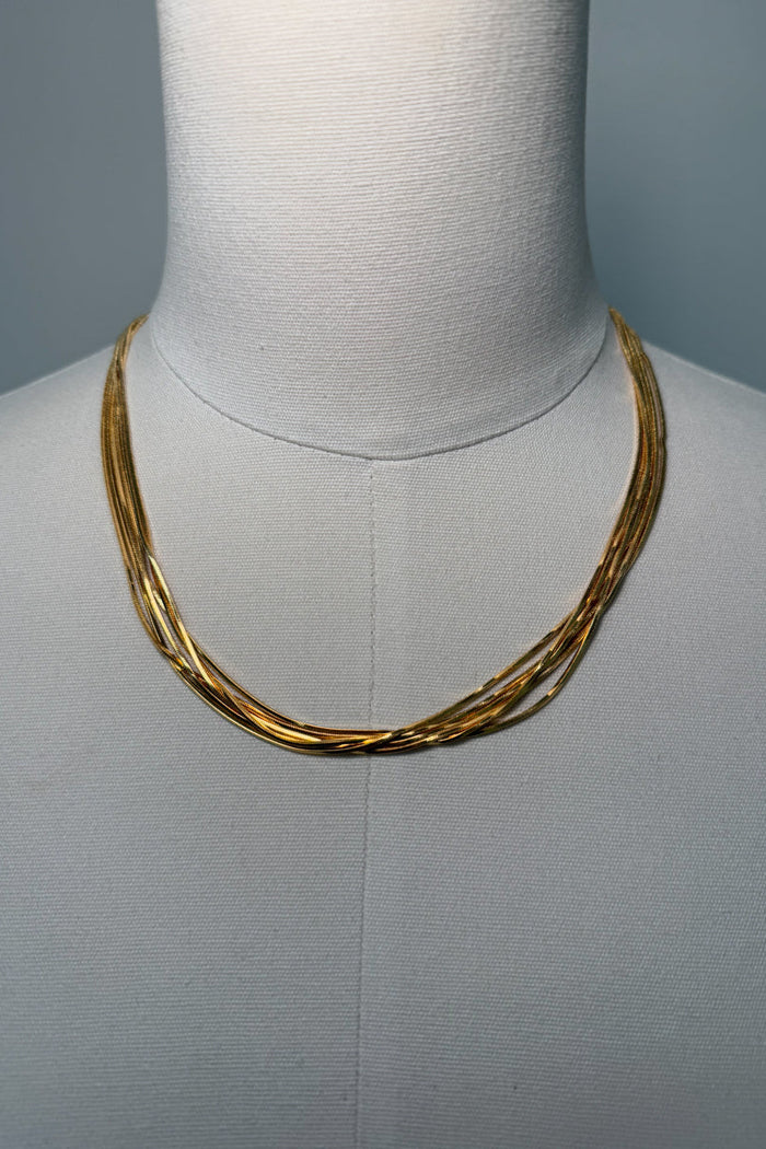 front-image | layered gold necklace | trendy jewelry | front view of a chic multi-layer gold necklace with intertwining chains