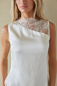White dress with lace detailing on a neutral background