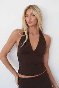 brown-image | Woman wearing a brown halter top against a white background