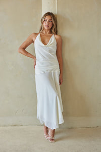 white-image | Woman wearing a white dress against a plain wall