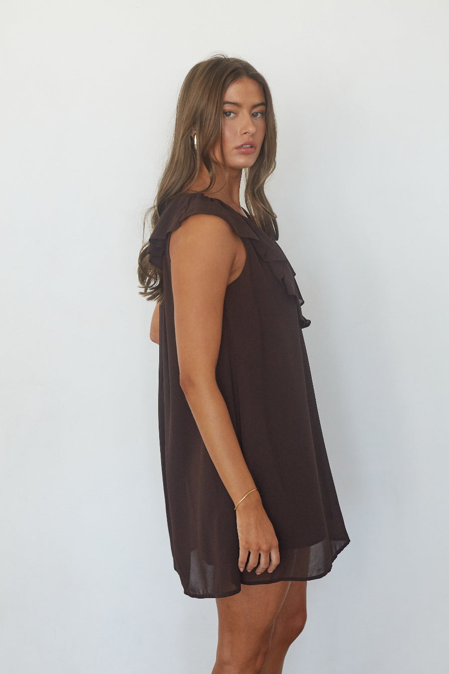 Chocolate brown ruffle chiffon babydoll mini dress, side profile view on model