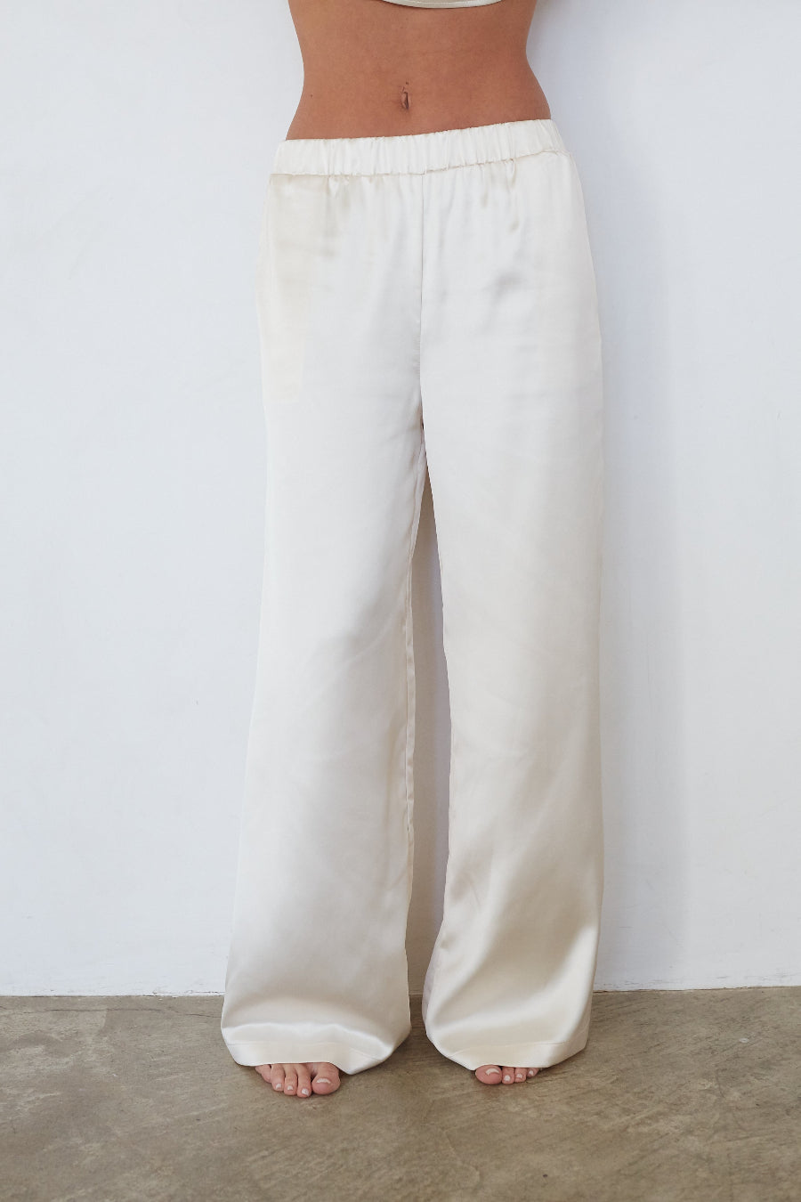 White wide-leg pants worn by a person on a plain background