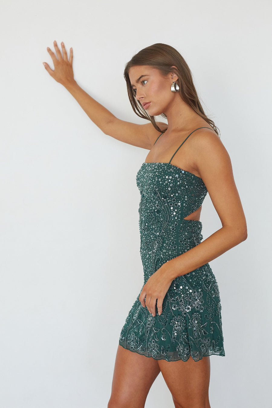 Emerald beaded sequin mini dress, side profile view showing fit and flare silhouette