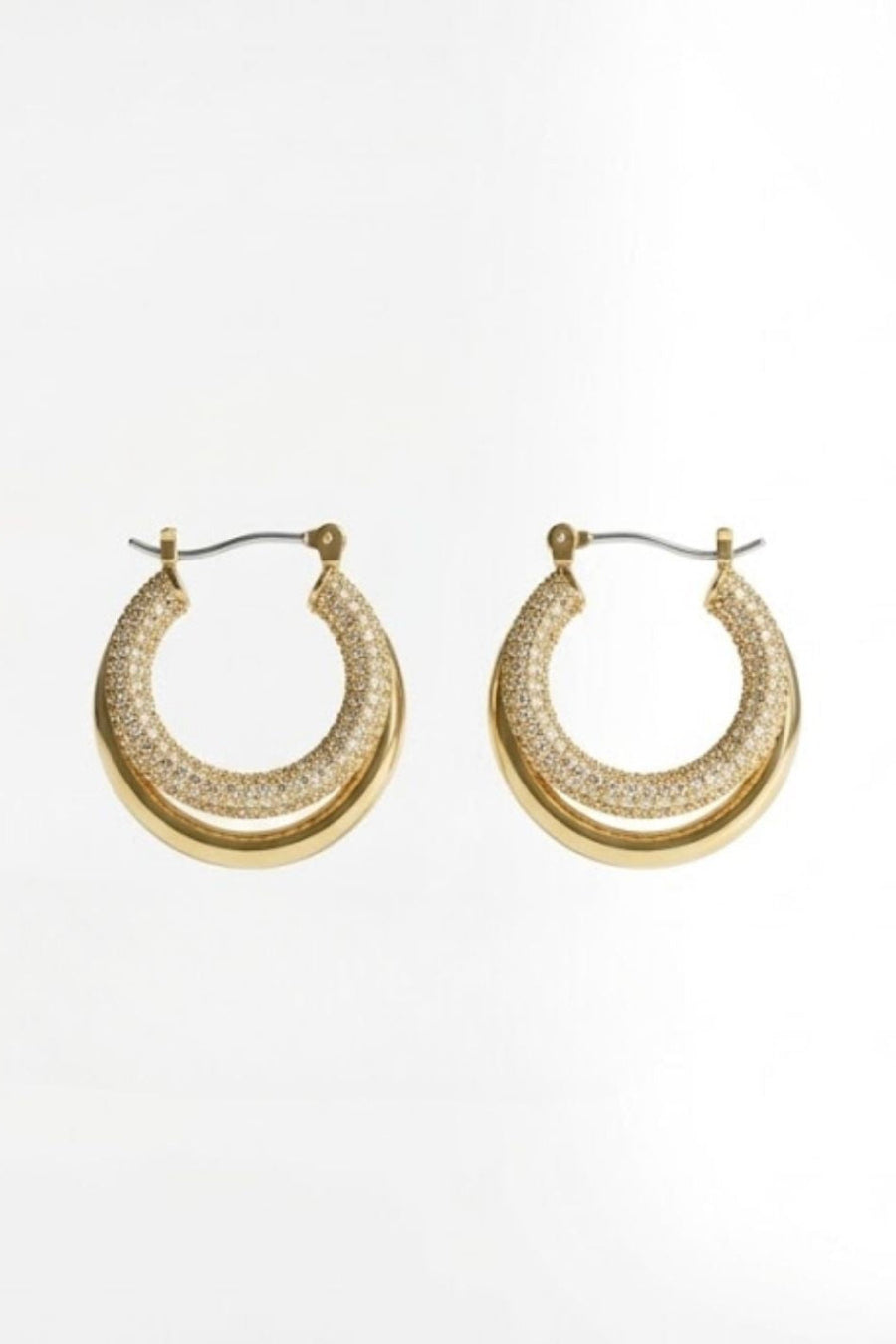 A pair of gold hoop earrings with a textured pavé-set crystal inner band and a polished gold outer rim, shown on a clean white background.