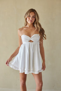 white-image | Woman wearing a white strapless dress against a plain background