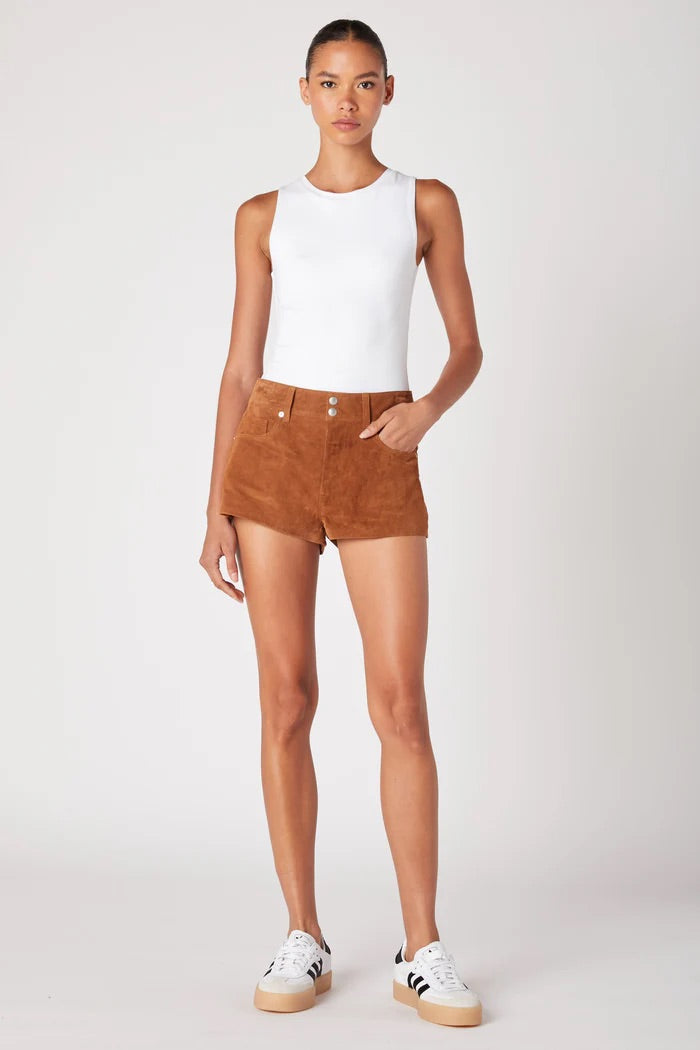 Person wearing a white sleeveless top and brown shorts on a white background