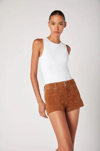 Woman wearing a white sleeveless top and brown shorts on a white background