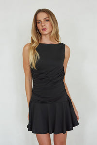 black-image | Woman wearing a black dress against a white background