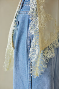 Light blue denim with lace trim top on a neutral background
