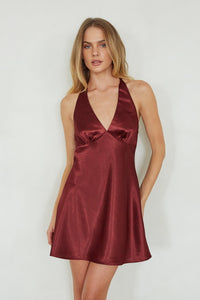 red-image | Woman wearing a burgundy satin dress against a white background