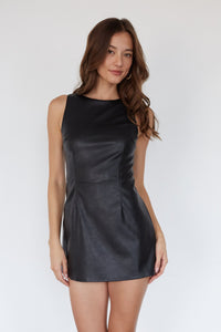 black-image | Woman wearing a black leather dress against a white background