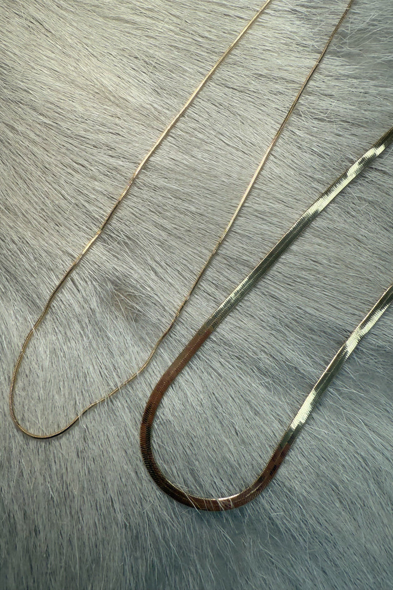 overhead-image | gold chains necklace | elegant accessory | top-down shot of two gold chains layered together