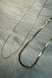 overhead-image | gold chains necklace | elegant accessory | top-down shot of two gold chains layered together