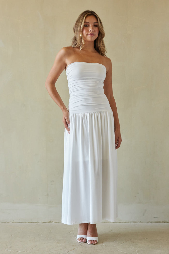 white-image | Woman wearing a white strapless dress against a plain background