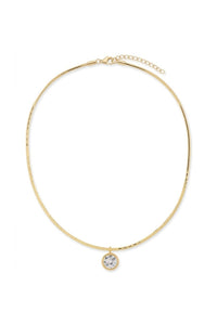 A delicate gold snake chain necklace with a small round bezel-set clear gemstone pendant, displayed on a clean white background.