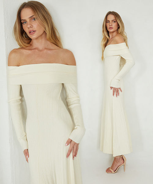 Woman wearing a white off-shoulder dress against a plain background