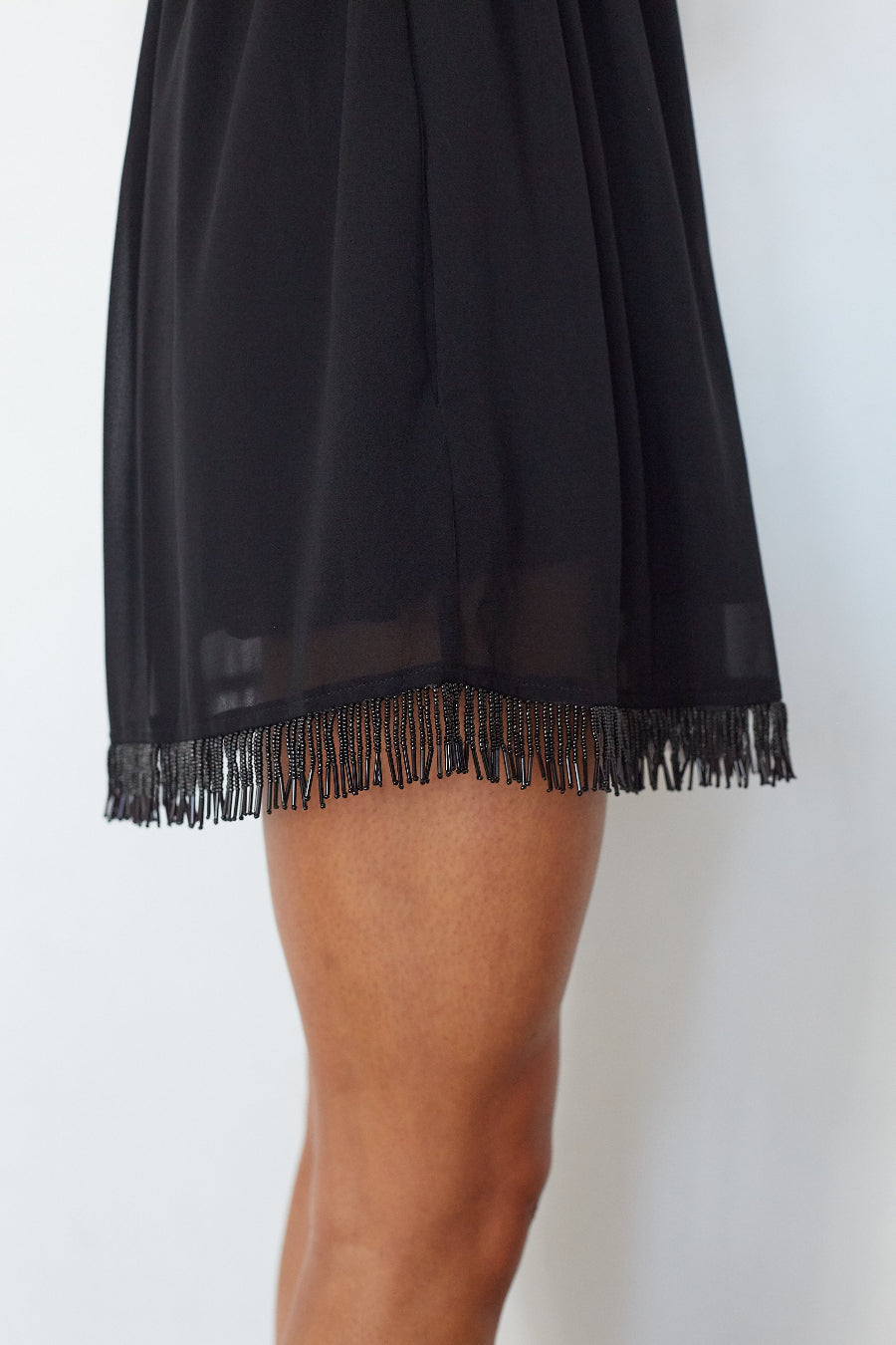 Close-up of the beaded fringe trim detail on the Olivia Beaded Fringe Mini Dress