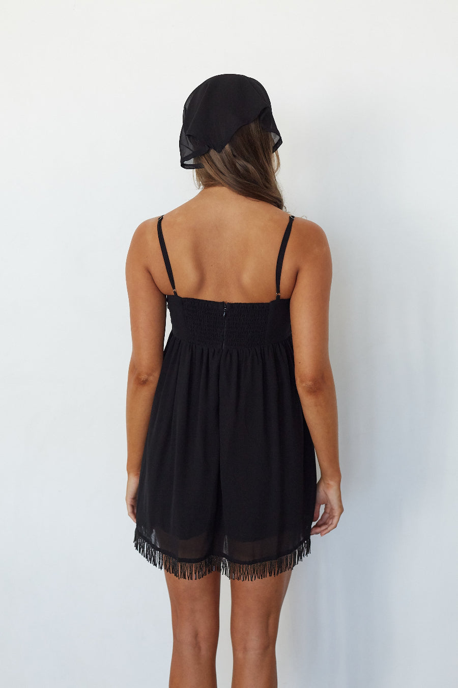 Model wearing the Olivia Beaded Fringe Mini Dress, back view