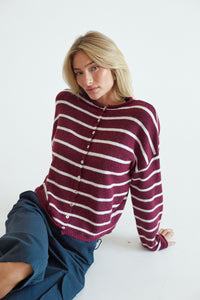 detail image of blonde image wearing a red and white striped sweater
