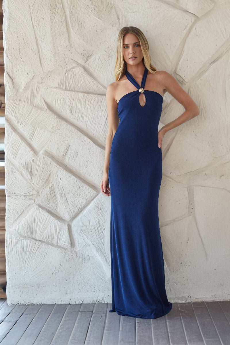 blue-image | Woman wearing a blue evening gown against a textured wall.