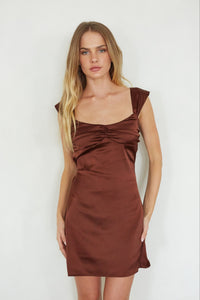 brown-image | front-image | Woman wearing a brown dress against a white wall