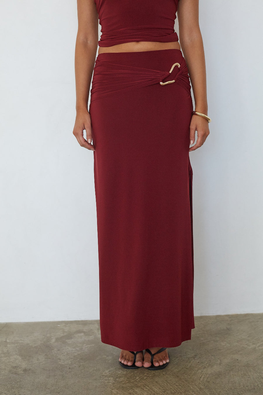 Burgundy ruched low waist maxi skirt, full-length front view on model