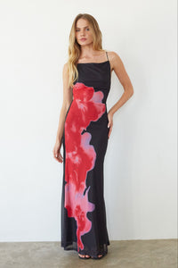 black-image | Woman wearing a black dress with red and pink abstract patterns against a white background