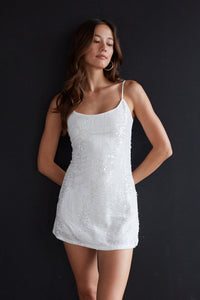 white-image | Woman wearing a white sequin dress against a black background